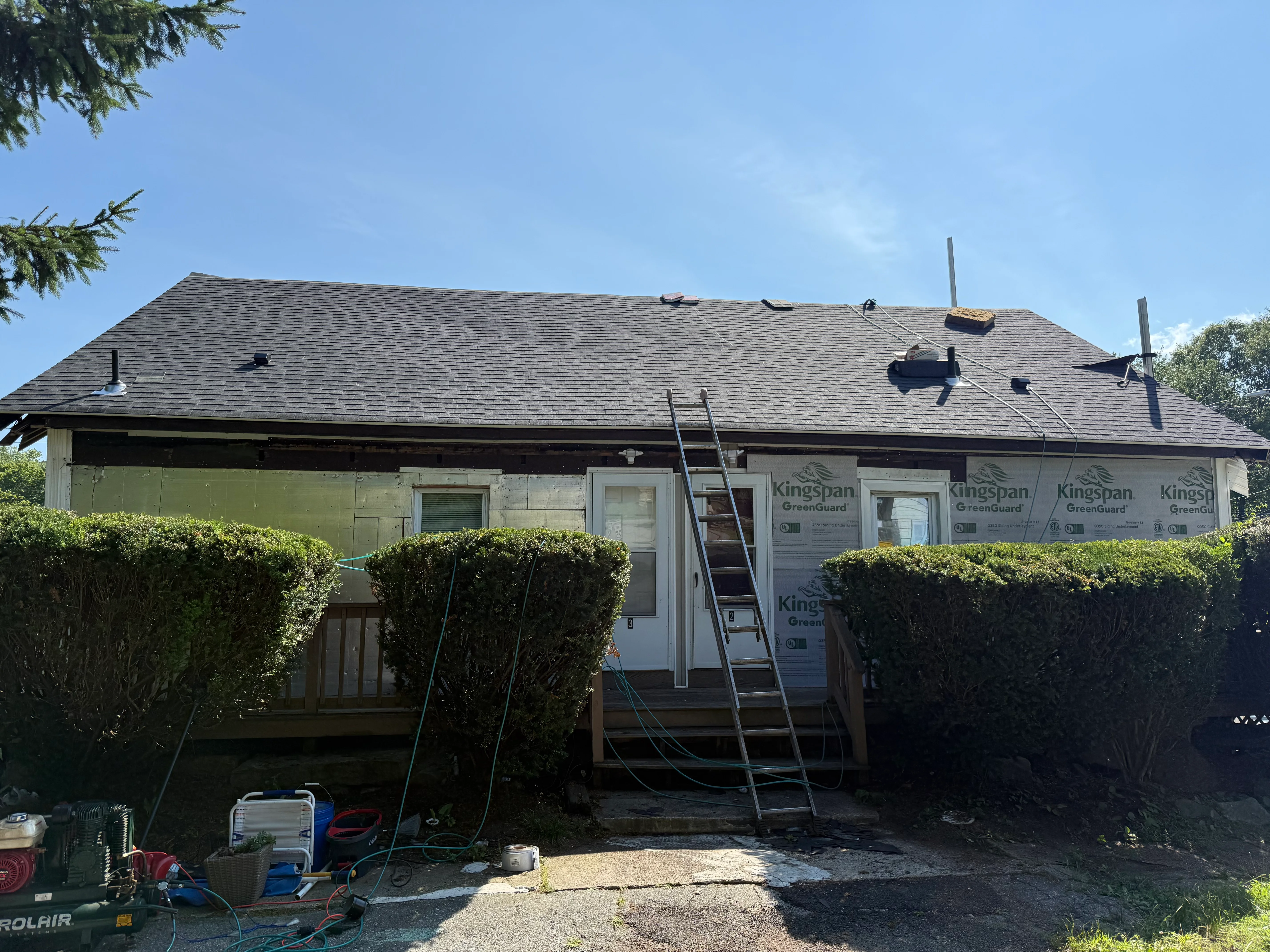 New gray architectural shingles installed on residential roof with flashing and vents